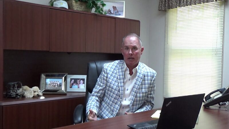 Sean Denny at his desk in the TriStar office, speaking to camera about why owners choose the firm