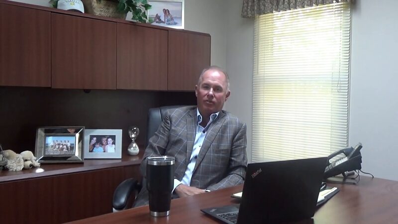 Sean Denny at his desk, describing the veterinary practice owners TriStar works with